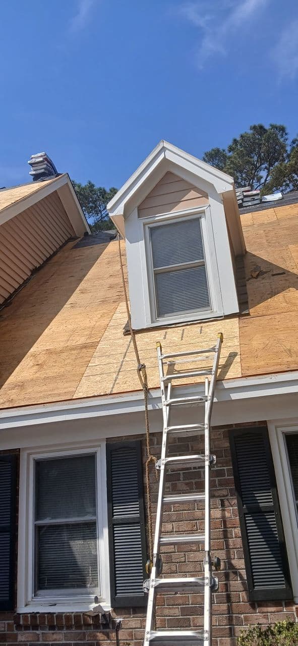 Ladder set up for safe roof access during a service call