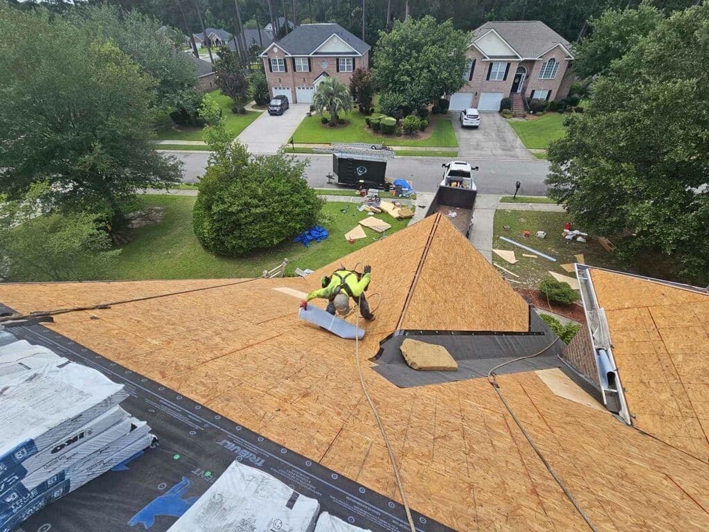 Roofer working on freshly installed roof decking