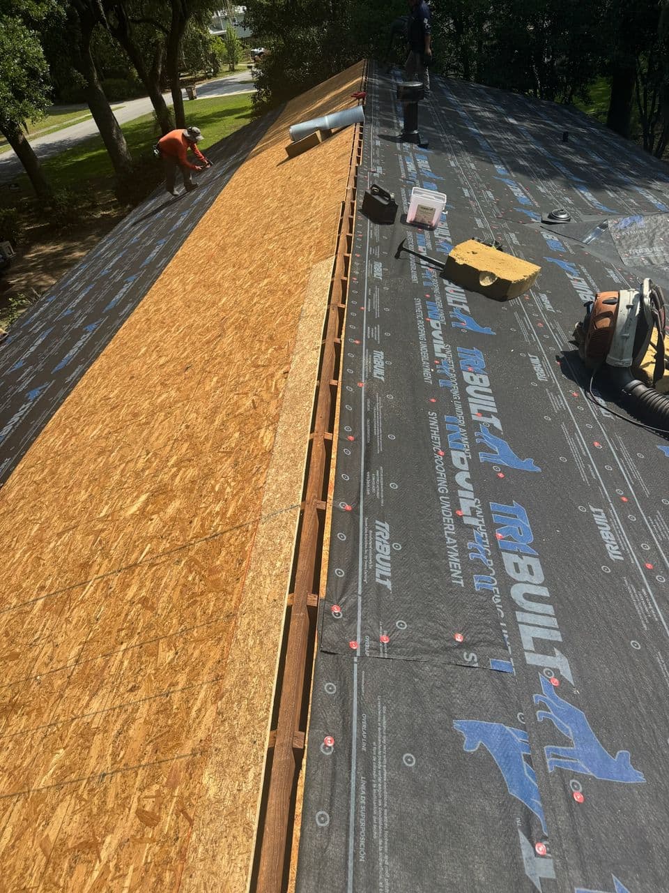Synthetic underlayment installed over new roof decking