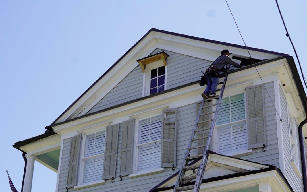 Tucker Contractors crew performing fascia and gutter service on a historic Charleston home